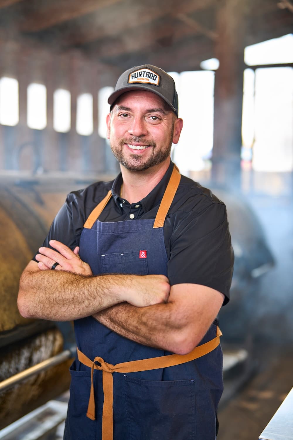 man at bbq smoker