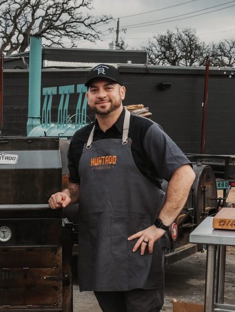 man at bbq smoker